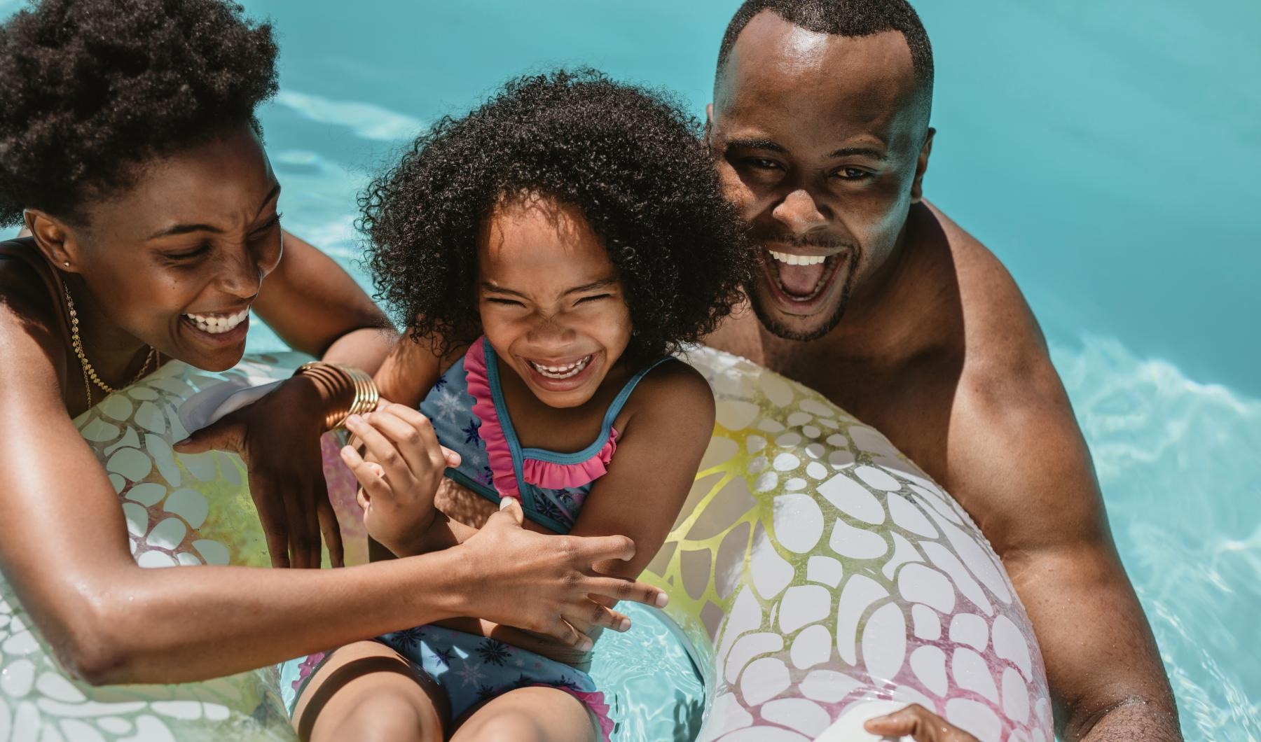 Sparkling swimming pool A smiling family in swimming pool at Heritage Grove apartments in Broken Arrow, OK