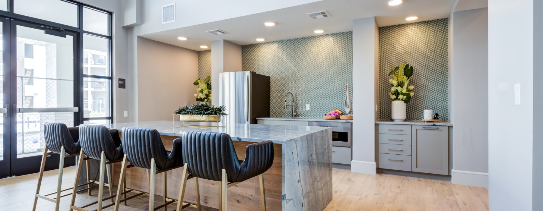 State-of-the-art amenities a clubroom kitchen with a large island and chairs