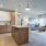 a kitchen and a living room with a couch, chair and a coffee table