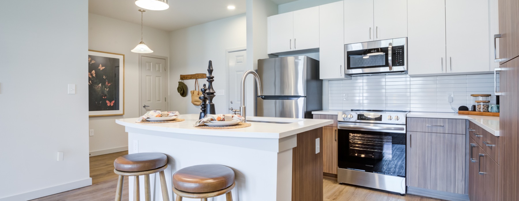 a kitchen with white and wood cabinets
