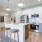 a kitchen with white and wood cabinets