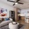 Living room with ceiling fan and bookcases at Heritage Grove apartment homes for rent in Broken Arrow, OK