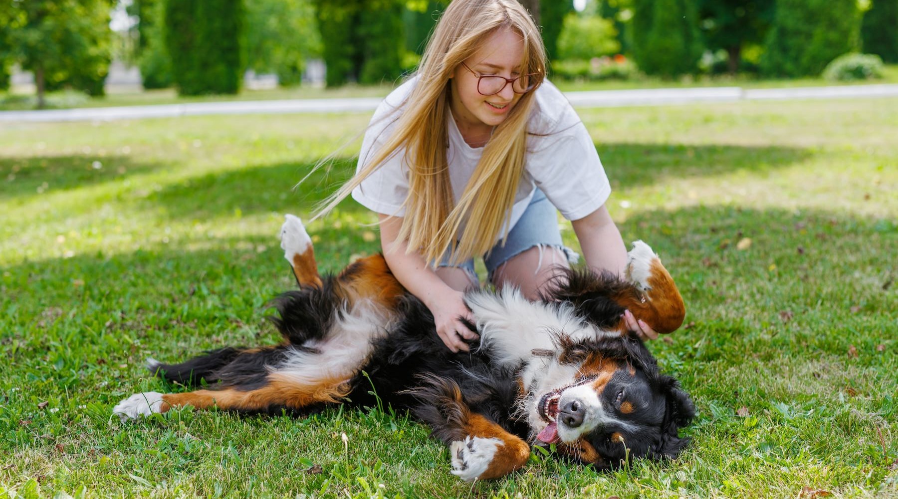 A beautiful community at the heart of all your passions A person petting a dog at Heritage Grove apartment homes for rent near Tulsa, OK